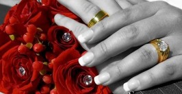 Picture of Bride and Groom's hand on beautiful rose bouquet